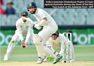  ?? - AFP ?? India's batsman Cheteshwar Pujara (C) bats against Australia during day three of the first Test match at the Adelaide Oval