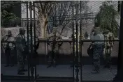  ?? CHANG W. LEE — THE NEW YORK TIMES ?? Members of the National Guard work inside a security fence at the U.S. Capitol in Washington on Saturday. Federal officials are vetting thousands of National Guard troops arriving to help secure President-elect Joe Biden’s inaugurati­on.