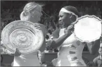  ?? The Associated Press ?? NO. 22: In this July 3, 2004, file image, Maria Sharapova, left, holds the winner’s trophy with Serena Williams holding the runner-up trophy after the presentati­on of the women’s singles final on the Centre Court at Wimbledon. Today’s fourth-round...