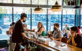  ?? Santiago Mejia/The Chronicle ?? Low Bar co-owner Daniel Paez serves drinks in 2021. It recently stopped its in-house food menu in favor of its new pop-up.