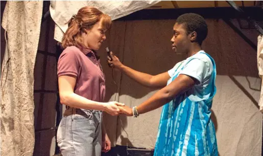  ?? LARA GOETSCH ?? Chris (Kearstyn Keller, left), the daughter of American missionari­es, and Adiel (Adia Alli), a local girl in Uganda, prepare to exchange vows in a secret ceremony in TimeLine Theatre’s production of “Cardboard Piano.”