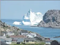  ?? FILE PHOTO ?? A large iceberg lingers just outside the harbour at Twillingat­e, N.L.