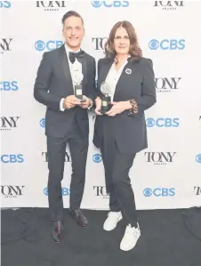  ?? — AFP photo ?? Bill Damaschke and Carmen Pavlovic, winners of the award for Best Musical for ‘Moulin Rouge! The Musical’ pose in the press room during the 74th Annual Tony Awards at Winter Garden Theatre in New York City.