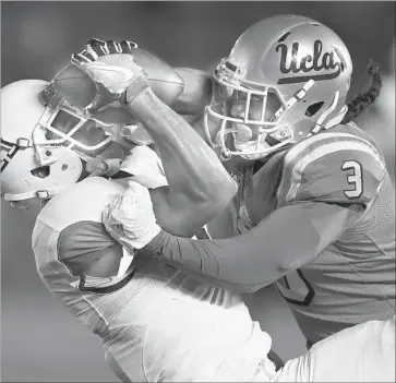  ?? Sean M. Haffey Getty Images ?? ARIZONA’S Trey Griffey gets behind UCLA’s Randall Goforth to haul in a 34-yard pass in the first quarter.