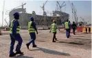  ?? HASSAN AMMAR/AP ?? Laborers head for Lusail Stadium, one of the 2022 World Cup venues, in Lusail, Qatar, in December 2019.