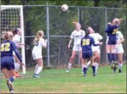  ?? PAUL DICICCO — THE NEWS-HERALD ?? Kirtland’s Lauren Lutz vies for a header as Wickliffe’s Jaina Buttari and the Hornets’ Lilia Valentic look on during a Division III district semifinal Oct. 23 at Kirtland.