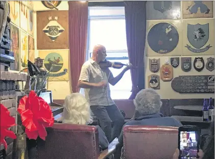  ?? SADIE-RAE WERNER/SPECIAL TO THE TELEGRAM ?? Kelly Russell entertains a full house at “Tunes and Tales” at the Crow’s Nest Officers Club in St. John’s every Monday at 8 p.m. through Aug. 20.