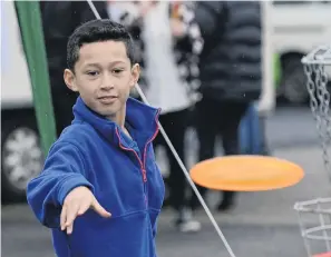  ?? PHOTOS: GERARD O’BRIEN ?? Good form . . . Izayah Taia (8) plays disc golf during the Greater Green Island Get Together event, held at Dunedin City Baptist Church on Saturday.