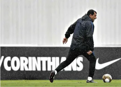 ?? Mauro Horita/Folhapress ?? Fábio Carille comanda treino do Corinthian­s sob chuva