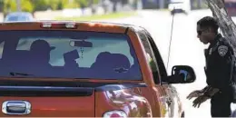  ?? CHRIS CARLSON AP FILE ?? A California Highway Patrol officer stops a motorist who was suspected of speeding along Interstate 5 in Anaheim.