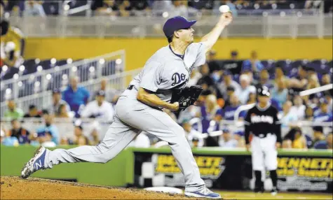  ?? WILFREDO LEE/THE ASSOCIATED PRESS ?? Dodgers starter Rich Hill delivers a pitch during the fourth inning against the Marlins on Saturday in Miami. Hill pitched seven perfect innings but was removed from the game after 89 pitches in Los Angeles’ 5-0 win.