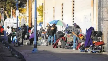  ?? K.C. ALFRED U-T FILE ?? As part of the new policy, police will not cite homeless people for illegal lodging or encroachme­nt violations when crews are cleaning sidewalks. The changes are expected to have the biggest impact in the East Village.