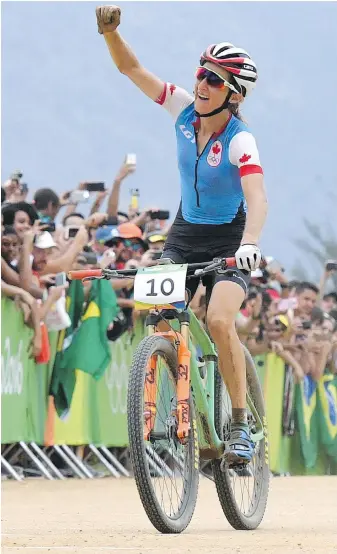  ??  ?? University of Victoria graduate Catharine Pendrel celebrates bronze in the mountain bike final at the Rio Summer Games on Saturday.