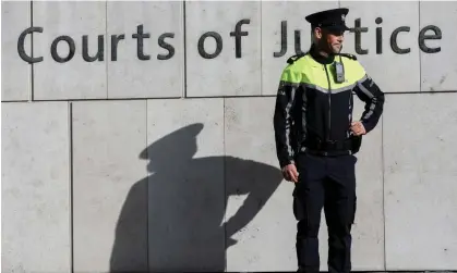  ?? Photograph: Lorraine O’Sullivan/Reuters ?? A police officer stands outside the special criminal court.