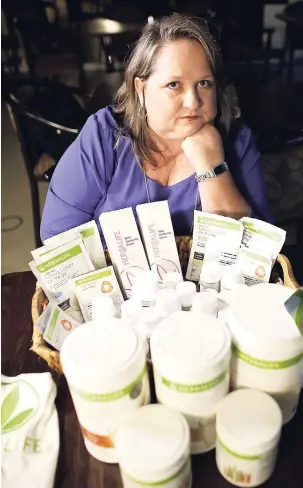  ?? AP P ?? In this November 14, 2017 photo, Patricia Rodgers poses with Herbalife products in Hallandale Beach, Florida. Rodge the multilevel marketing company that sells its products through a network of distributo­rs, who recruit more distributo­This May 11, 2016 file photo shows Herbalife protein bars at Herbalife’s corporate office in Los Angeles.