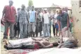  ??  ?? BLOOD ON THE STREETS: Residents look at slain bodies in Bujumbura on Wednesday.