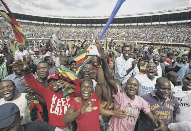  ?? PICTURE: BEN CURTIS/AP ?? Zimbaweans celebrated yesterday as Emmerson Mnangagwa was sworn in as the country’s new president at a ceremony in Harare