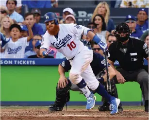  ?? (Robert Hanashiro-USA TODAY Sports) ?? LOS ANGELES DODGERS third baseman Justin Turner hits an RBI single in the seventh inning of NLCS game five at Dodger Stadium.