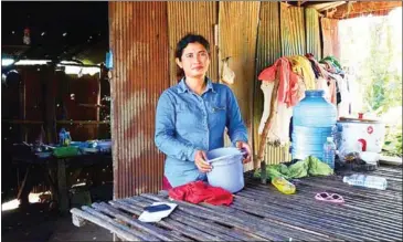  ?? TAN HUI LEE/THE STRAITS TIMES ?? Ren Ruon, 40, a villager in Kampong Cham province, uses a microloan to finance her small business selling fruit to factory workers. However, she admits she loses sleep sometimes thinking about the land that she could lose as collateral if she ever defaults on repayment.