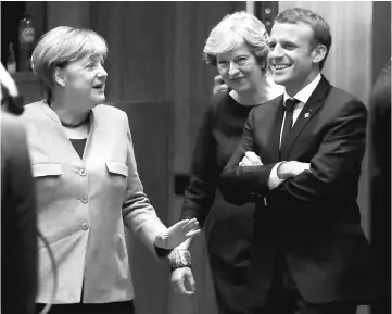  ??  ?? Merkel (left) May (centre) and Macron arrive at a EU summit in Brussels, Belgium. — Reuters photo