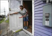  ?? GERALD HERBERT / ASSOCIATED PRESS ?? Luz Ramirez closes the door at one of her son Alex’s eight short-term rental properties after cleaning it in Mid City New Orleans.