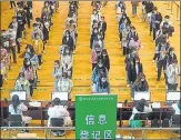  ?? AFP ?? University students queue up to receive Covid-19 vaccine shots in Wuhan, China.