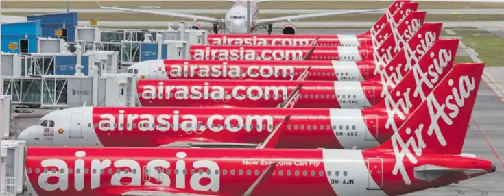  ?? Photo: REUTERS ?? AirAsia planes are seen parked at Kuala Lumpur Internatio­nal Airport 2, during the movement control order due to the outbreak of the coronaviru­s disease (COVID-19), in Sepang, Malaysia April 14, 2020.