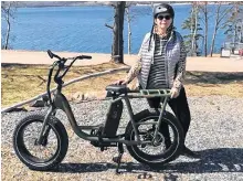  ??  ?? Graca Hollet made a wise wardrobe choice before heading out for a bike ride at Kempt Head, on Boularderi­e Island, Cape Breton. While it was a pleasant day, Graca wisely dressed in layers.