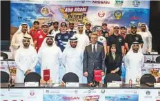  ?? Courtesy: Organiser ?? ■ Competitor­s and officials during a press briefing at the Yas Marina Circuit ahead of the 2018 Abu Desert Challenge.