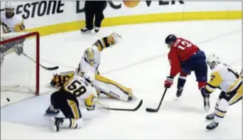  ?? ALEX BRANDON — THE ASSOCIATED PRESS ?? Washington’s Jakub Vrana (13) scores the go-ahead goal past Pittsburgh goaltender Matt Murray (30) and defenseman Kris Letang (58) during the third period of Game 5 on Saturday in Washington.