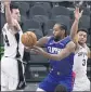  ?? DARREN ABATE — THE AP ?? The Clippers’ Kawhi Leonard, center, passes as he is defended by San Antonio’s Drew Eubanks, left, and Keldon Johnson.