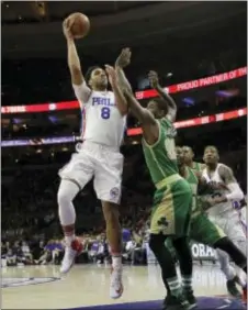  ?? MATT SLOCUM — THE ASSOCIATED PRESS ?? The 76ers’ Jahlil Okafor puts up a shot very early in Sunday’s game against Boston. Okafor left the game after just two minutes and never returned with knee soreness.