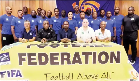  ??  ?? CONCACAF Instructor­s Juan Carlos Michia ( left) and Lenny Lake (2nd left), GFF President Wayne Forde (centre), GFF Technical Director Ian Greenwood (2nd right), Executive Committee member Keith O’Jeer (right) and the participat­ing coaches (standing)...