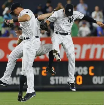  ?? NOAH K. MURRAY/USA TODAY SPORTS ?? Yankees teammates Brett Gardner, Jacoby Ellsbury and Tyler Austin celebrate their win over the Blue Jays.