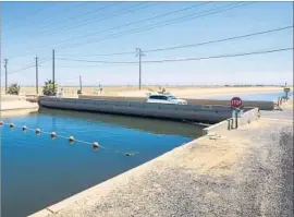  ?? Florence Low California Department of Water Resources ?? A BRIDGE had sunk almost as low as the canal surface in Firebaugh, Calif., in this 2015 image. Subsidence in the Central Valley persists at an alarming rate.