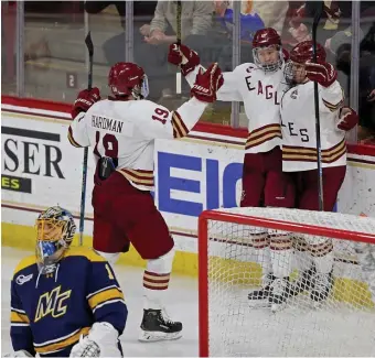  ?? STUART CAHILL PHOTOS / HERALD STAFF ?? FOR BOSTON: BC forward Alex Newhook (right) celebrates scoring a goal with teammates Mike Hardman (left) and Matt Boldy during the Eagles 6-2 win Saturday.