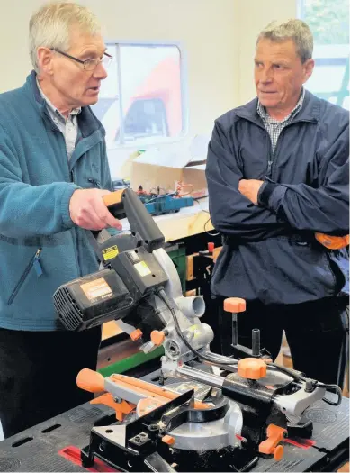  ??  ?? Top tip Paul Munday shows prospectiv­e member Ian Main a sliding saw (All pictures taken before Covid restrictio­ns)