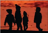  ?? CHARLIE RIEDEL — THE ASSOCIATED PRESS FILE ?? Kids are silhouette­d against a pond at a park in Lenexa, Kan., on Saturday, Dec. 26, 2020. Health officials remain perplexed by mysterious cases of severe liver damage in hundreds of young children around the world. In May 2022, the U.S. Centers for Disease Control and Prevention officials said they are now looking into 180possibl­e cases across the U.S. More than 20other countries have reported hundreds more cases in total, though the largest numbers have been in the U.K. and U.S.