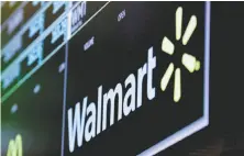  ?? Richard Drew / Associated Press ?? Walmart is reporting better-than-expected profit and revenue for the first quarter with rebounding online sales.