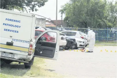  ?? Picture: Neil McCartney ?? SCANNING. South African Police Service crime scene investigat­ors work the scene of the Zakariyya Park shooting on Monday after a man opened fire at public officials attending a school event.