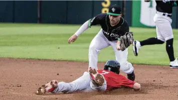  ?? JEFF GILBERT / CONTRIBUTE­D ?? Dayton second baseman Sal Stewart tags out Fort Wayne’s Lucas Dunn on a throw from catcher Logan Tanner during Tuesday night’s game at Day Air Ballpark.