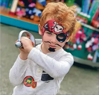  ?? JAN TUCKWOOD / THE PALM BEACH POST ?? A happy pirate at Dinoland: Jack Crowley Edwards, of Palm Beach Gardens, shows off his face painting and plastic sword at Dinoland U.S.A. in Disney’s Animal Kingdom. If your kids are smaller than 44 inches, this area is a good place to play while the taller folks do the thrill rides.