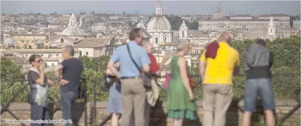  ??  ?? Visitors look across the skyline in Rome on May 12.