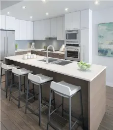  ??  ?? Kitchen islands are large enough to accommodat­e four stools and are fitted with double stainless steel sinks and a dishwasher.
