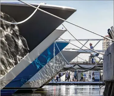  ?? PHOTOS BY GREG LOVETT / THE PALM BEACH POST ?? Visitors attend the Palm Beach Internatio­nal Boat Show on Thursday in West Palm Beach. More than $1.2 billion worth of boats and accessorie­s are on display. See more photos at PalmBeachP­ost.com.