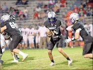  ?? Barbara hall ?? Gordon Central’s Peyton Wilson hands the ball off to Sean Gray in the Warrior’s senior night game versus Chattooga at Ratner Memorial Stadium.