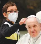  ?? Reuters ?? A boy approaches Pope Francis during the weekly general audience at the Vatican yesterday.