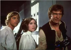  ?? LUCSAFILM VIA AP ?? Mark Hamill, Carrie Fisher, and Harrison Ford, from left, starred in the 1977 film “Star Wars.”