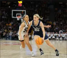 ?? Adam Bettcher/Getty Images ?? Penn Staet’s Makenna Marisa drives for the lane as Iowa’s Gabbie Marshall defends in the quarterfin­als Friday of the Big Ten tournament at Target Center in Minneapoli­s.