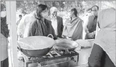  ??  ?? ISLAMABAD
A lady street vendor expressing her gratitude for Ehsaas Rehribaan Project to Dr. Sania Nishtar, which provided her licensed and improved vending cart. -APP